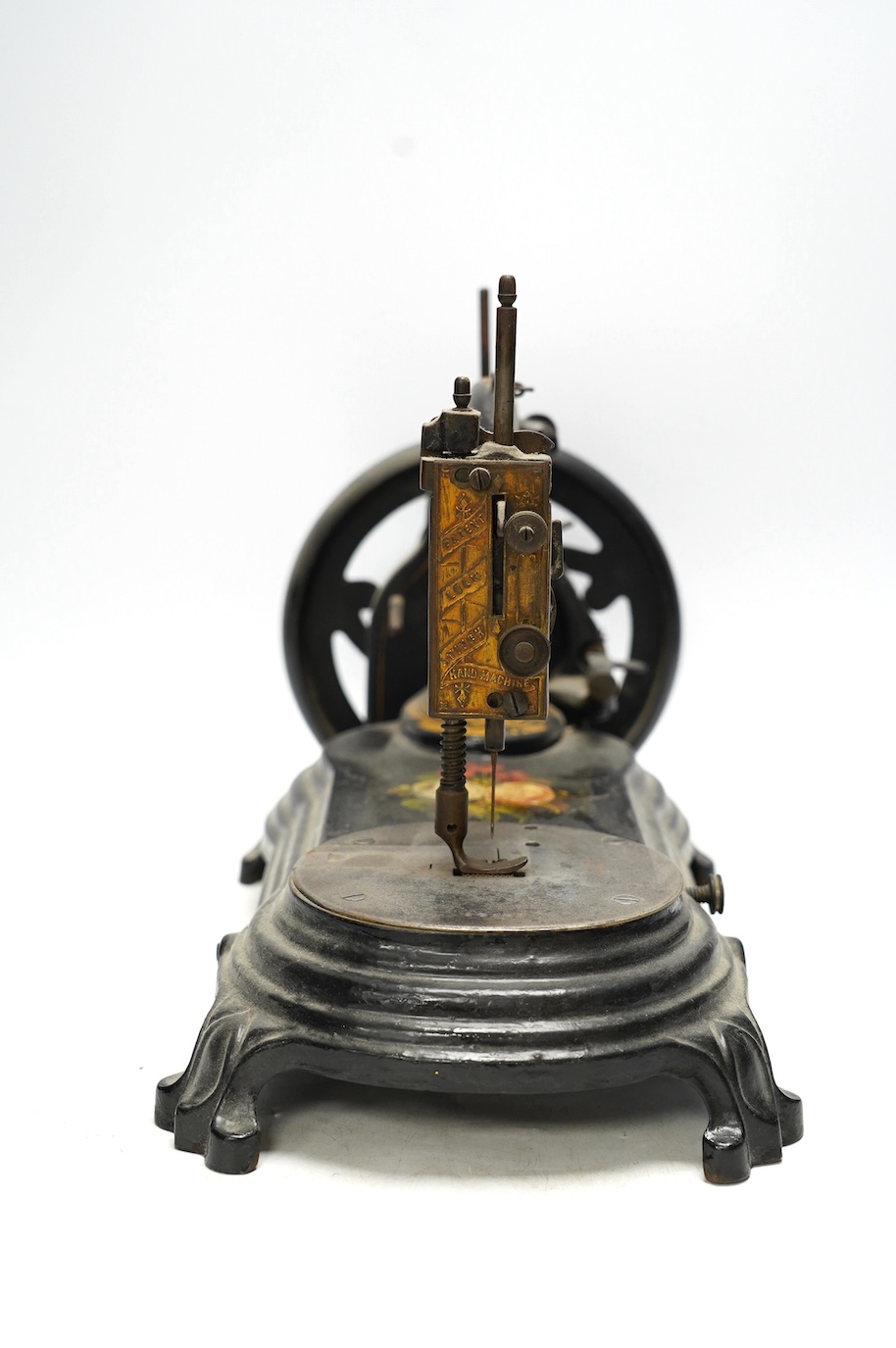 A late 19th century Bradbury & Co Wellington sewing machine on a cast iron base with gilt and floral decoration. Condition - fair